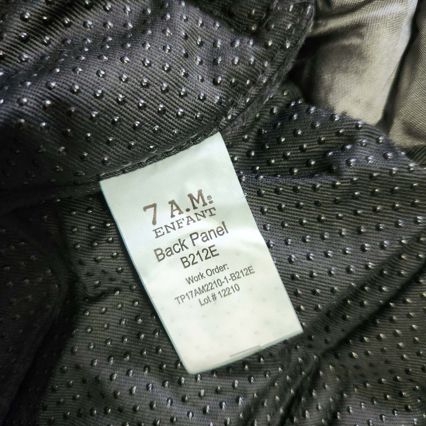 A metallic grey 7AM Enfant stroller blanket label