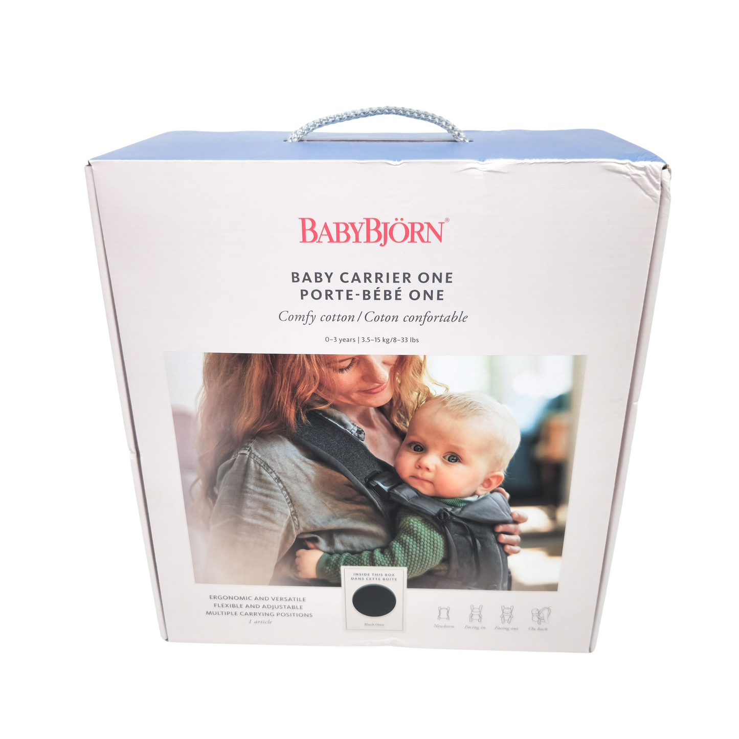 Packaging box for BABYBJÖRN Baby Carrier One in Black Cotton with image of a mother holding a baby and the carrier itself.