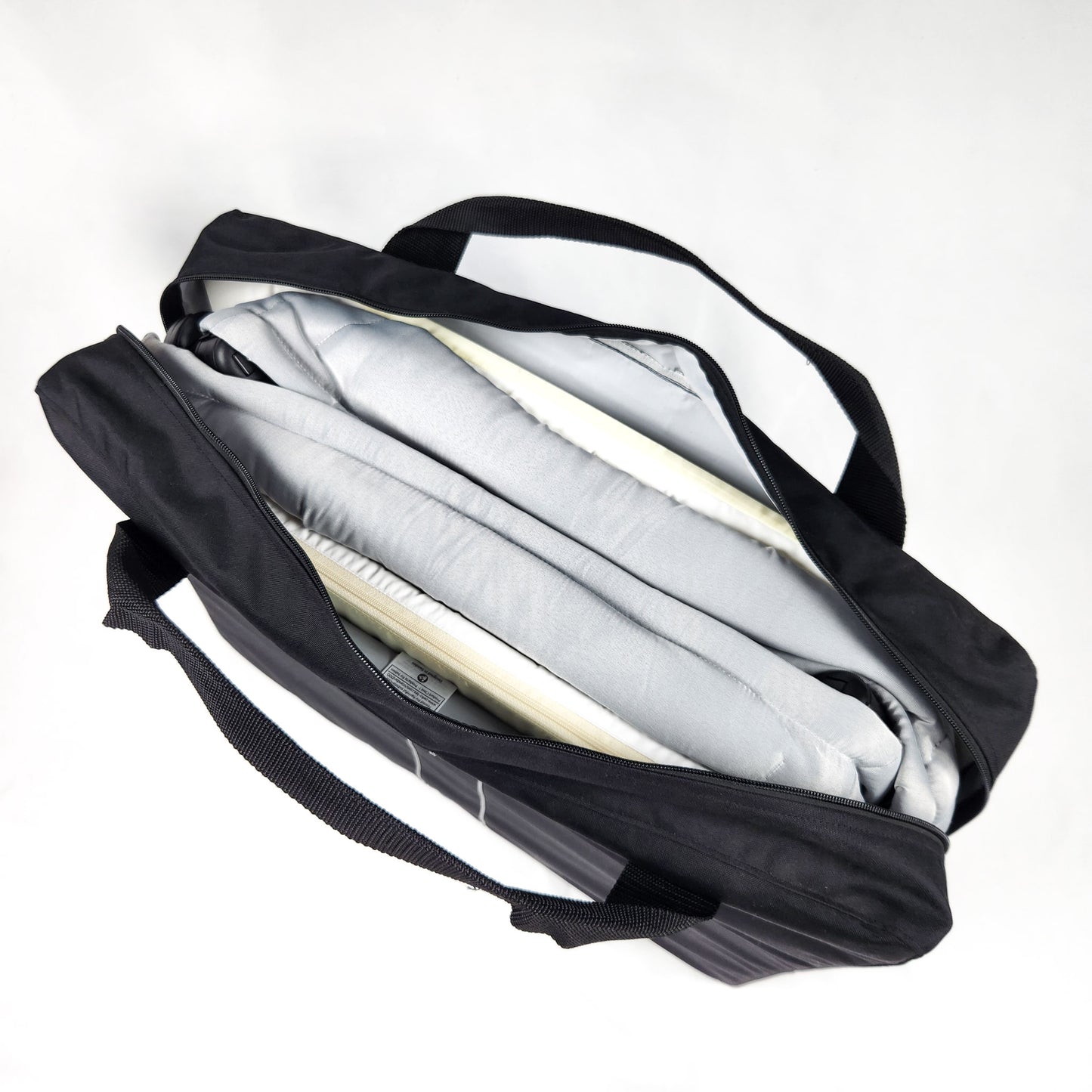 BABYBJÖRN Play Yard Light with Carry Bag - Silver folded inside the travel storage bag