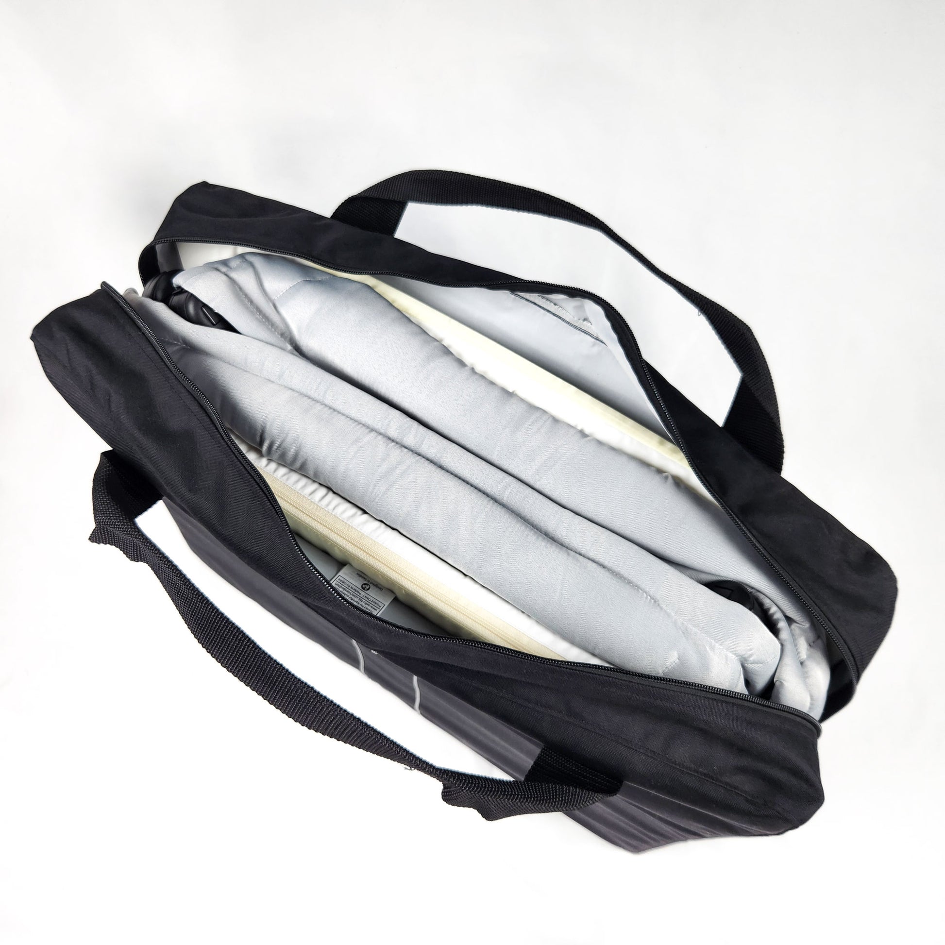 BABYBJÖRN Play Yard Light with Carry Bag - Silver folded inside the travel storage bag