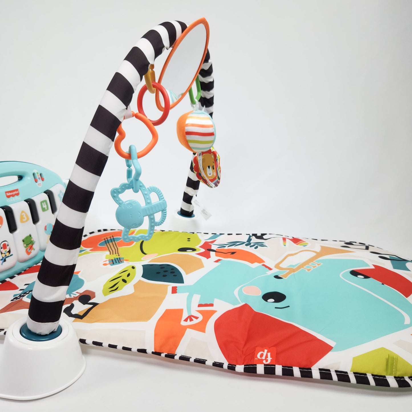 Fisher-Price Glow and Grow Kick & Play Piano Gym playmat with a blue piano gym and interactive toys on a colorful background.