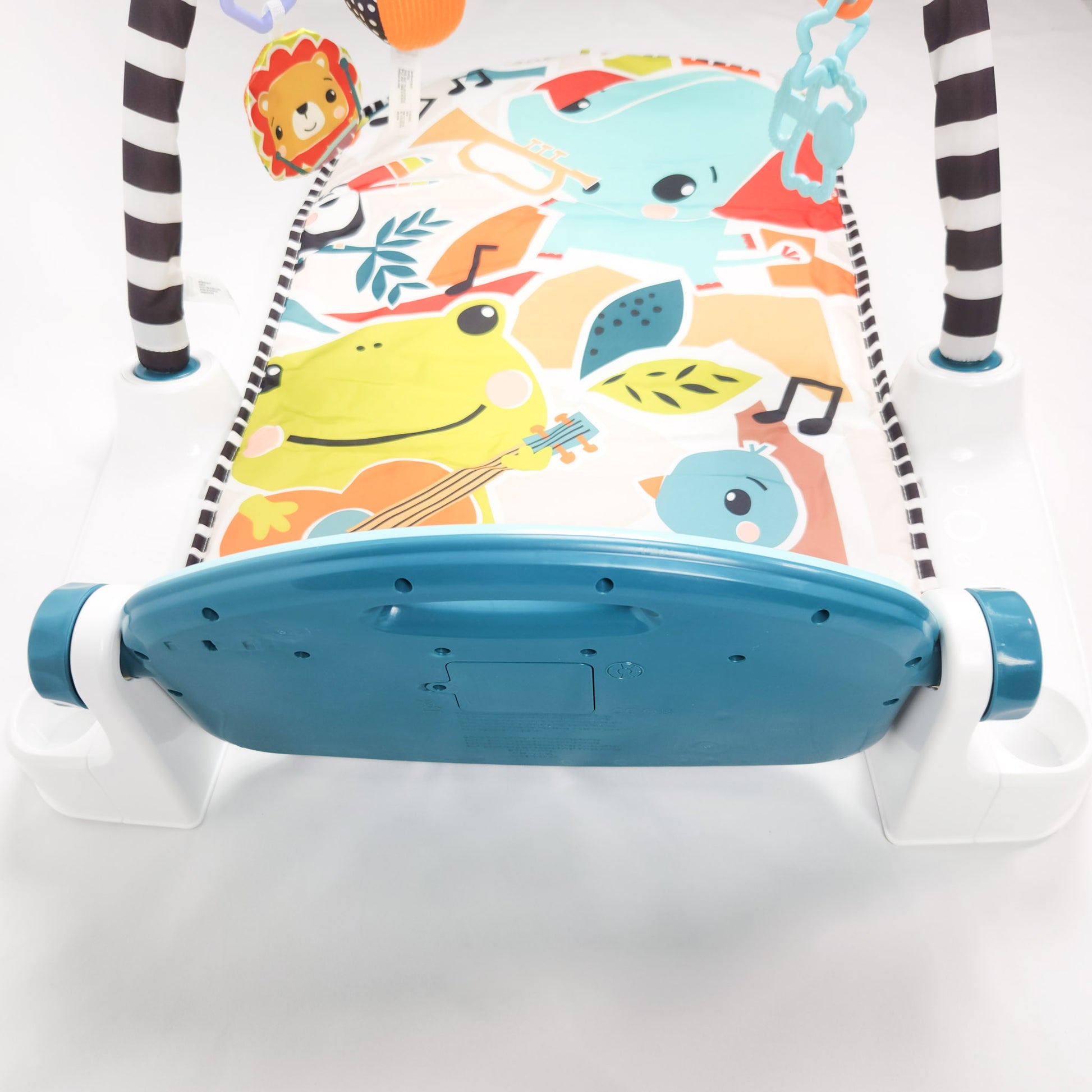 Fisher-Price Glow and Grow Kick & Play Piano Gym playmat with a blue piano gym and interactive toys on a colorful background top view back of pinano