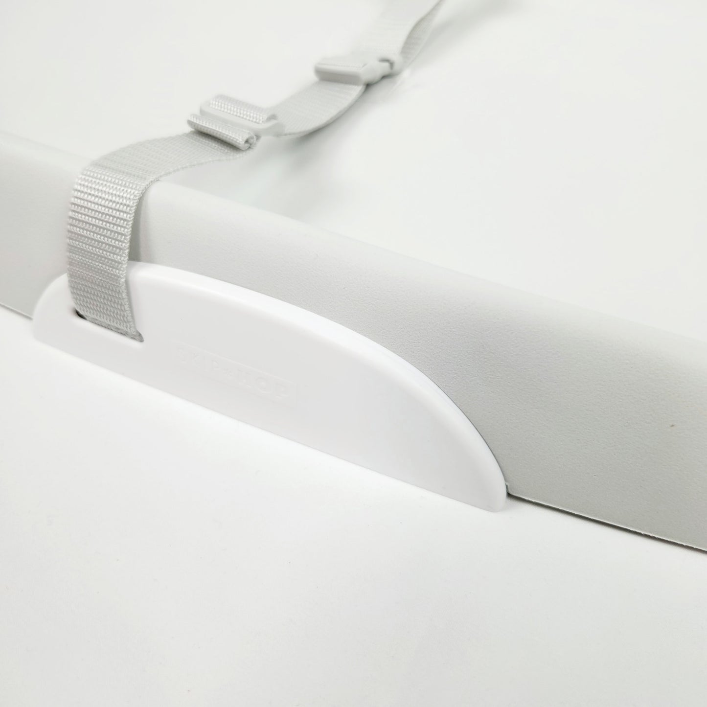 Skip Hop baby changing pad in grey showing safety strap and brand logo on the side