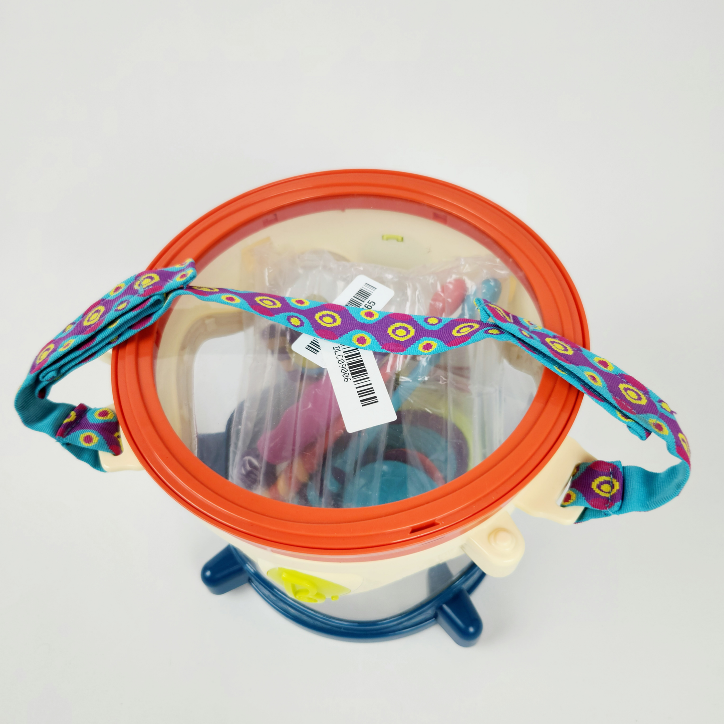 B Toys musical toy drum kit with instruments top view showing drum, strap and included instruments inside