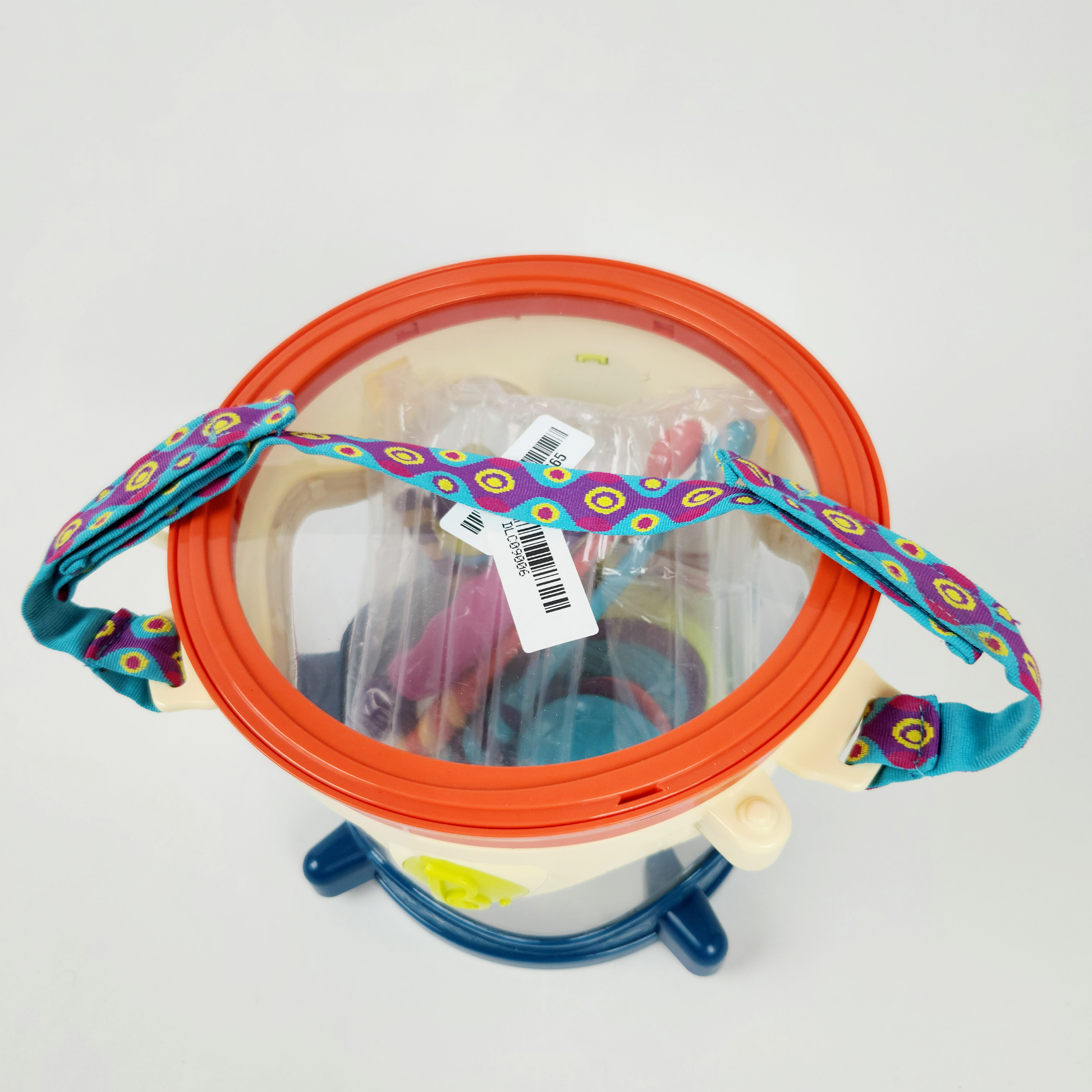B Toys musical toy drum kit with instruments top view showing drum, strap and included instruments inside