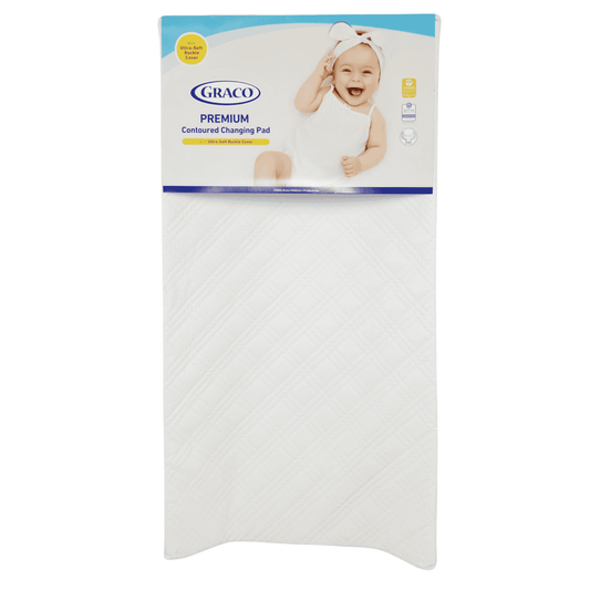 Graco Premium Contoured Changing Pad in white, with a visible blue and white packaging showing the product name and a baby image.