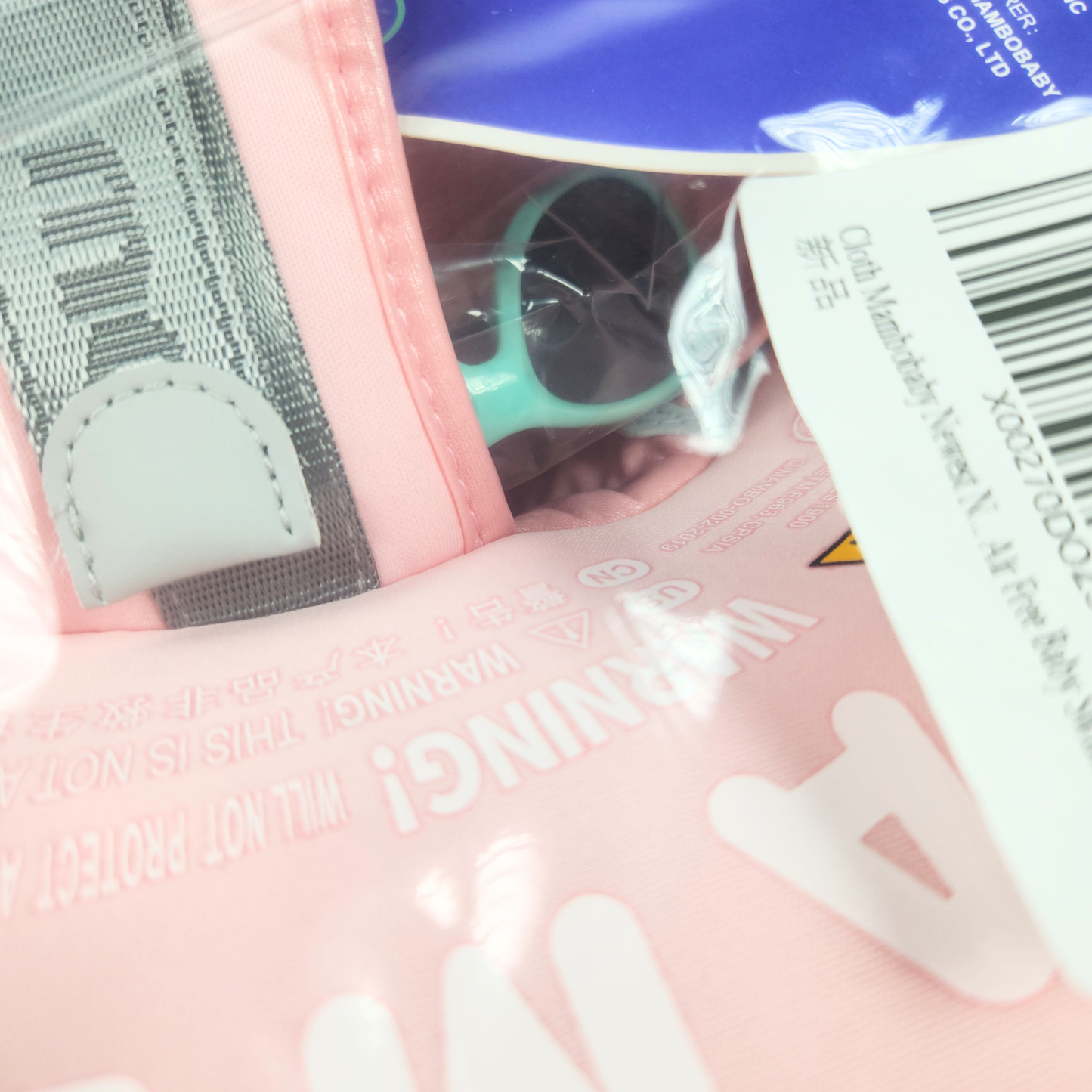 Pink baby float with gray straps and Mambobaby branding packaging on it sealed close up
