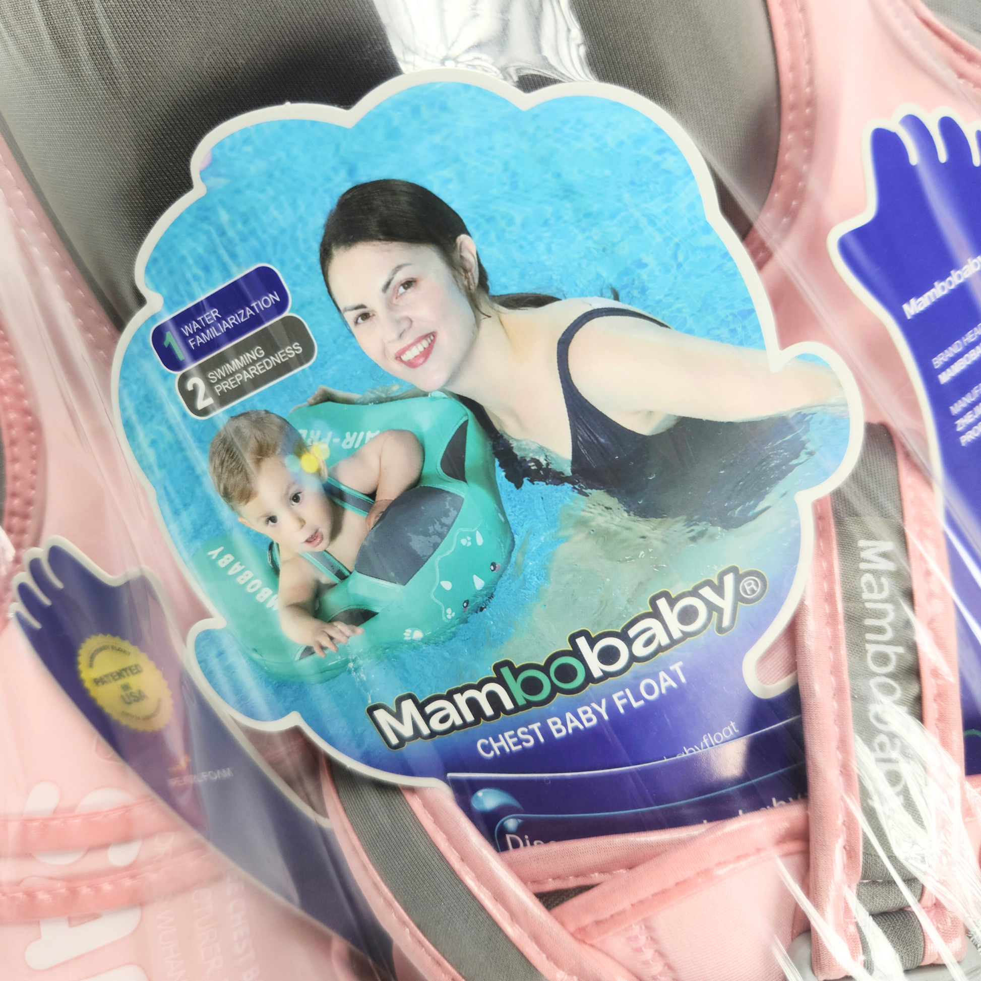 Pink baby float with gray straps and Mambobaby branding packaging on it sealed close up