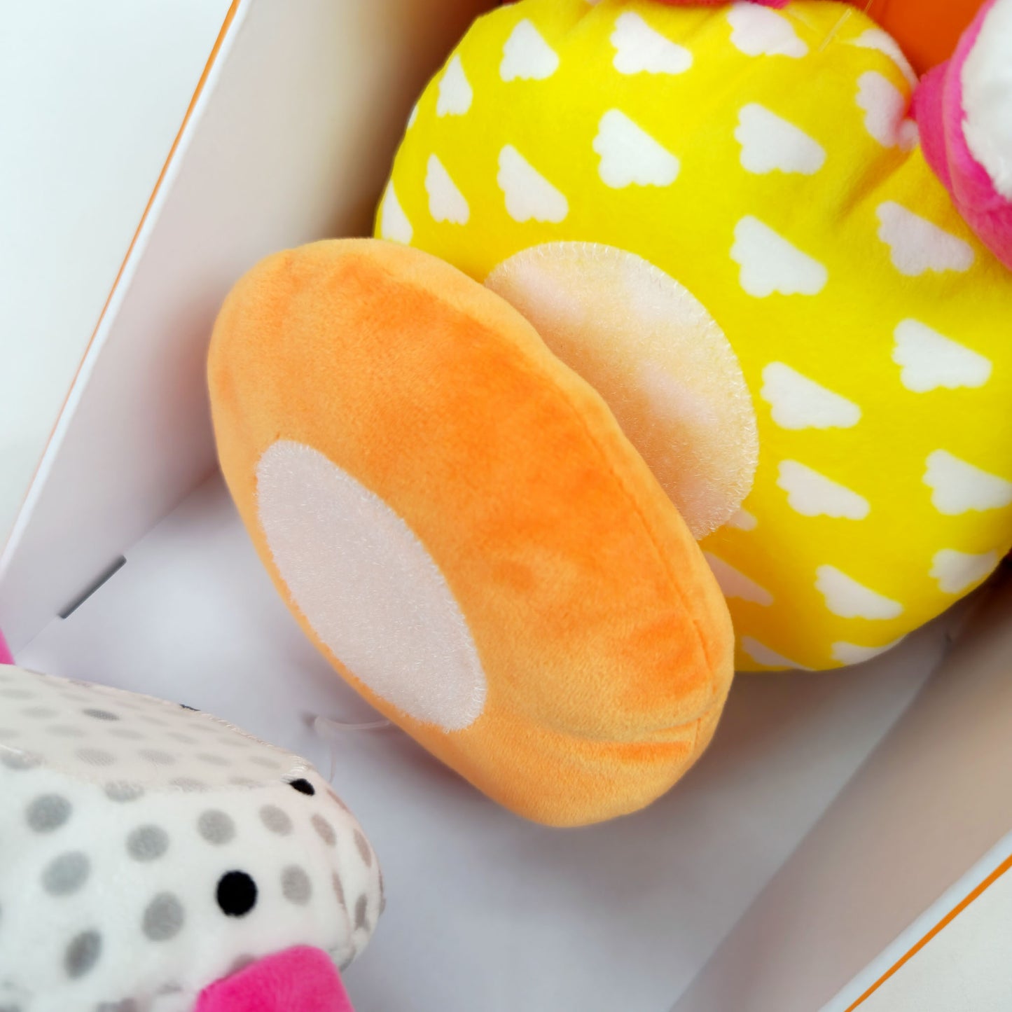 Giggle soft stacker baby toy pink hippo plush with colorful stacking rings in packaging showing close up detail