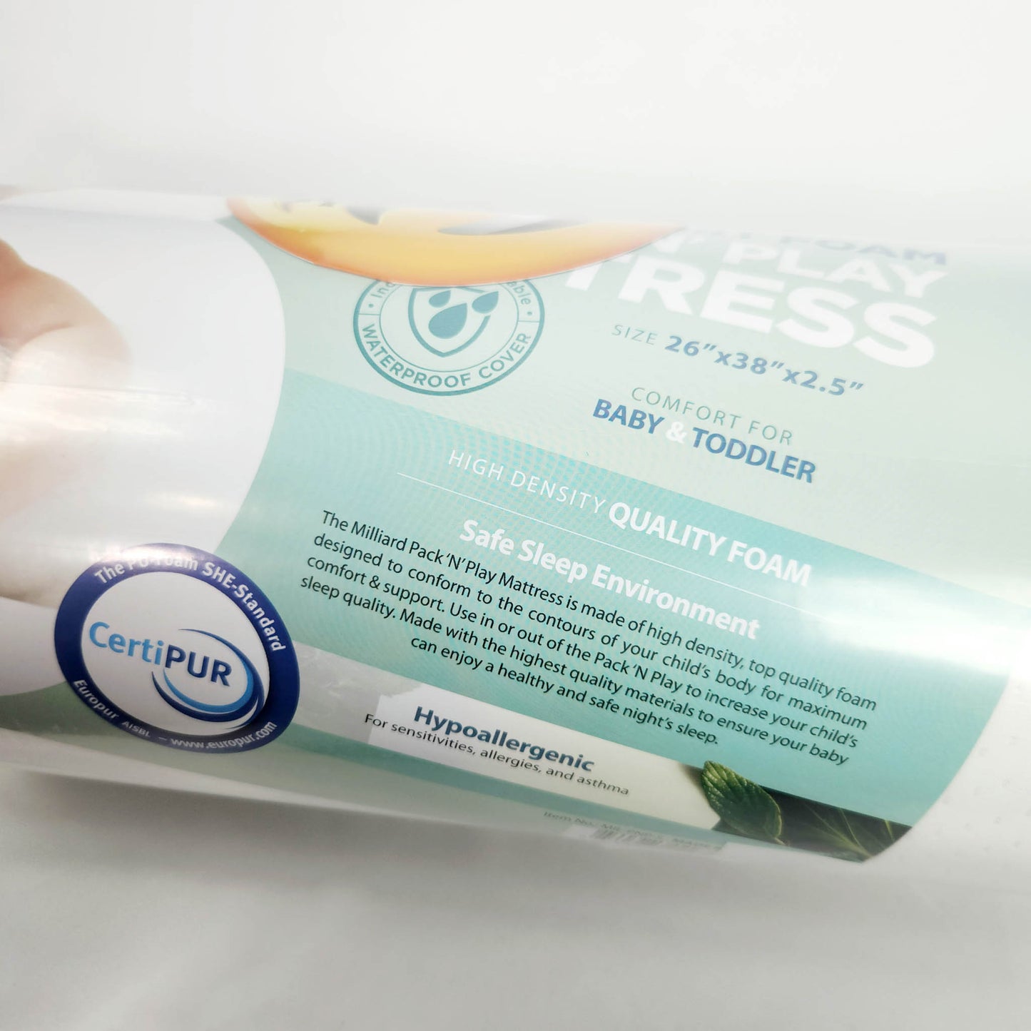 Milliard pack and play foam mattress topper rolled and sealed in packaging close up