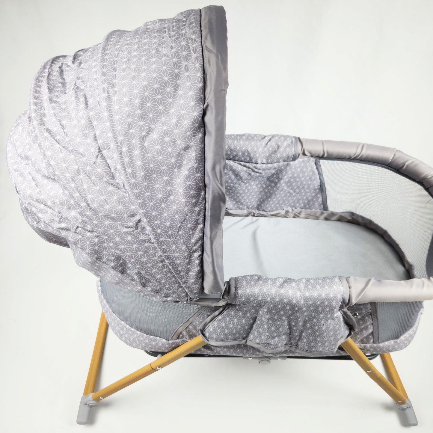 Safety 1st Amherst bassinet Stardust front view showing mesh sides, padded edges, canopy, and wooden legs