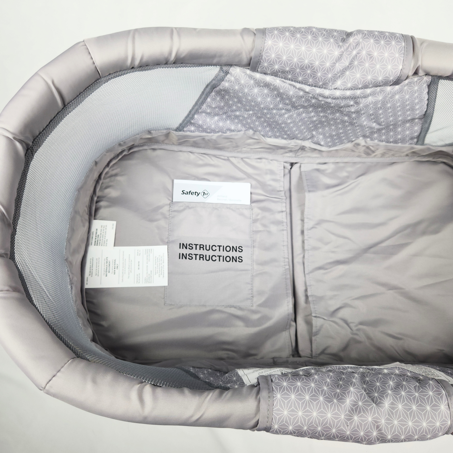 Safety 1st Amherst bassinet Stardust front view showing mesh sides, padded edges, and where the manual is